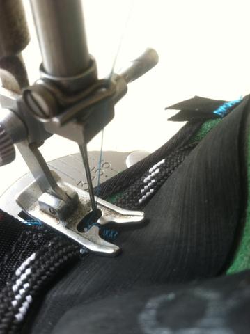 Stitching new laces in.